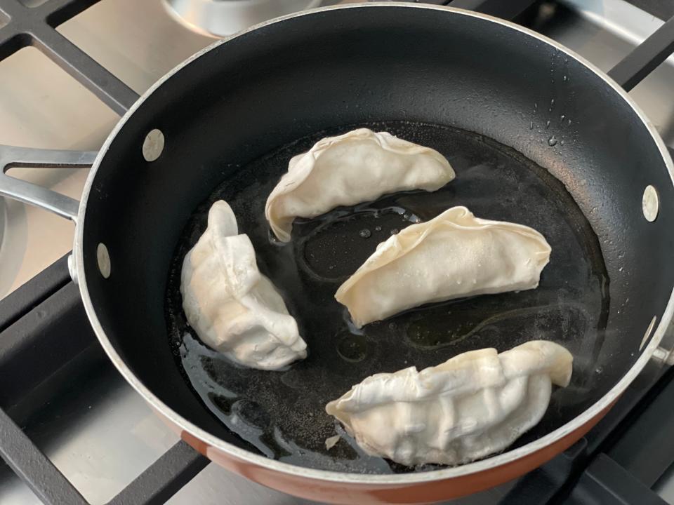 potstickers in a pan on the stove