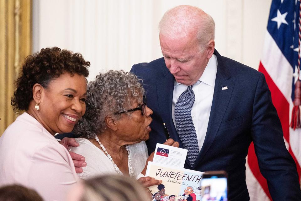 Ninety-four-year-old activist and retired educator Opal Lee, known as the Grandmother of Juneteenth, speaks with U.S. President Joe Biden after he signed the Juneteenth National Independence Day Act into law in the East Room of the White House on June 17, 2021 in Washington, DC