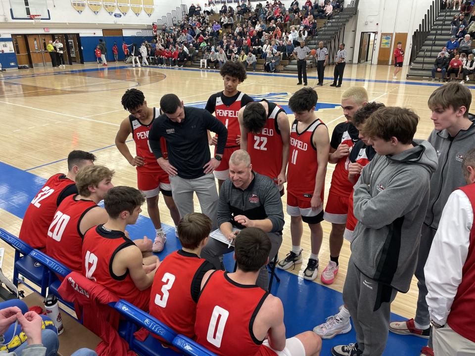 Penfield coach Jason Ellis talks to his team during a 51-50 win at Webster Schroeder in the Section V Class AA quarterfinals Saturday, Feb. 24, 2024. Trevor Hofer, 0, scored the game-winning basket as time expired.