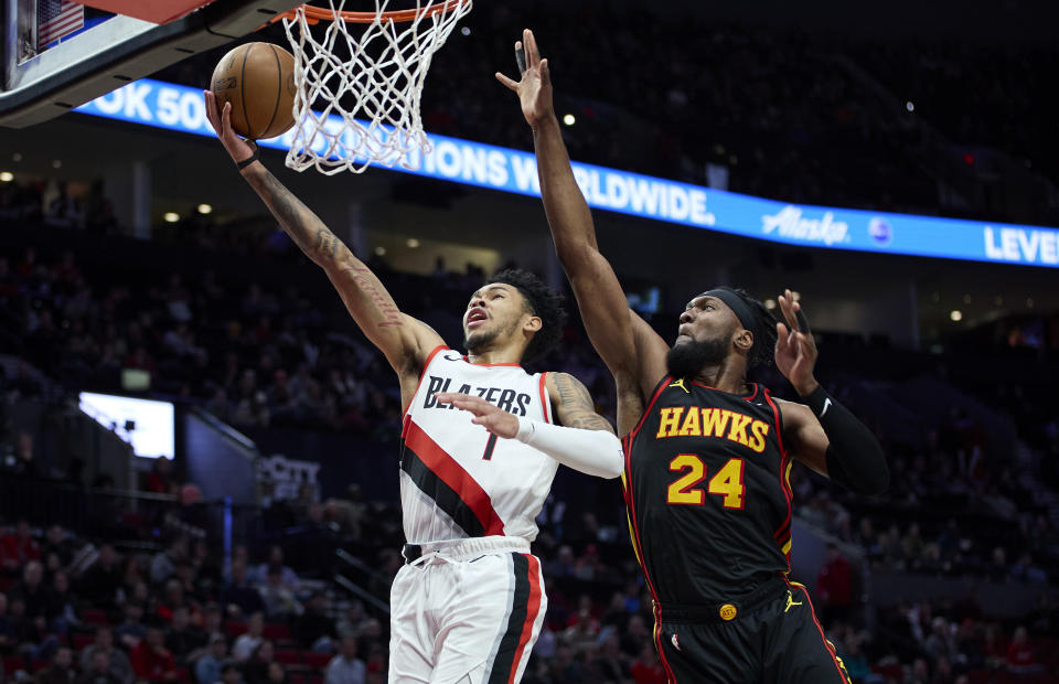 Portland Trail Blazers guard Anfernee Simons, left, shoots in front of Atlanta Hawks forward Bruno Fernando during the second half of an NBA basketball game in Portland, Ore., Wednesday, March 13, 2024. (AP Photo/Craig Mitchelldyer)