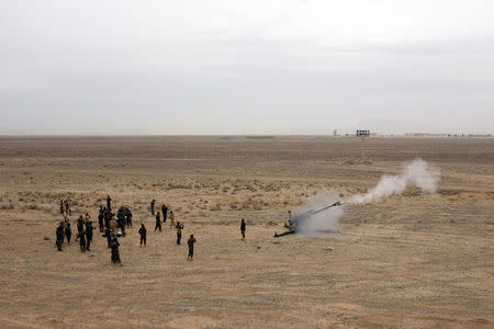 Afghan troops fire a 122mm howitzer during a live-fire exercise with NATO military advisers outside Kandahar Air Field, Afghanistan, February 15, 2017. Picture taken February 15, 2017. REUTERS/Josh Smith