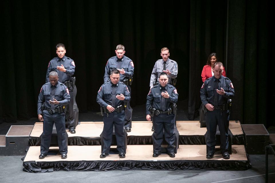 The Pueblo Police Department Class 64 recruits recite an oath of honor during their law enforcement academy graduation ceremony at Memorial Hall on Friday, March 25, 2022.