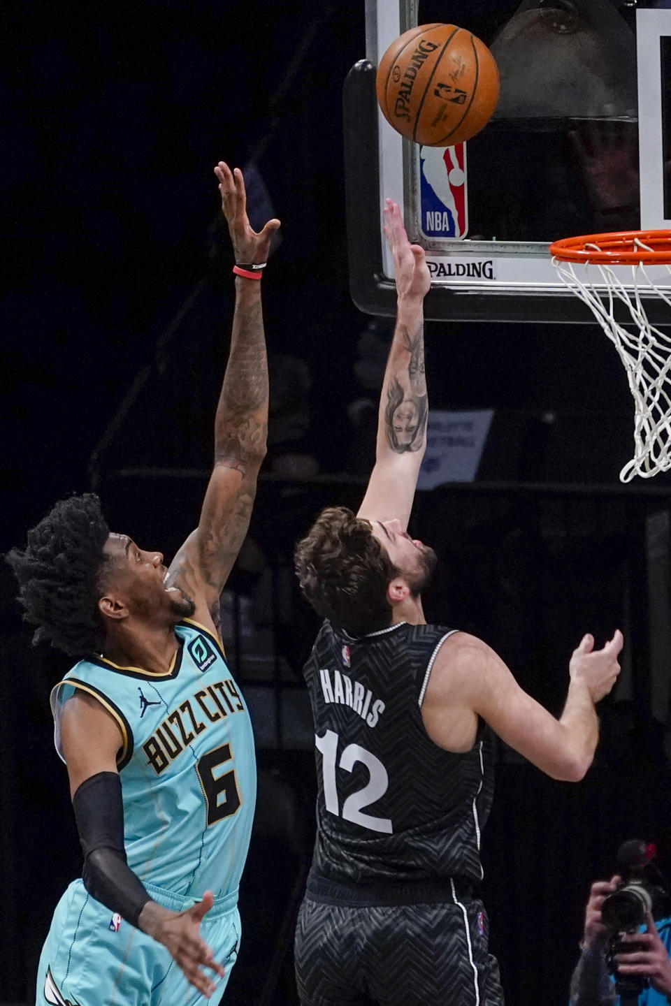 Brooklyn Nets forward Joe Harris (12) goes to the basket past Charlotte Hornets forward Jalen McDaniels (6) during the second half of an NBA basketball game Friday, April 16, 2021, in New York. (AP Photo/Mary Altaffer)