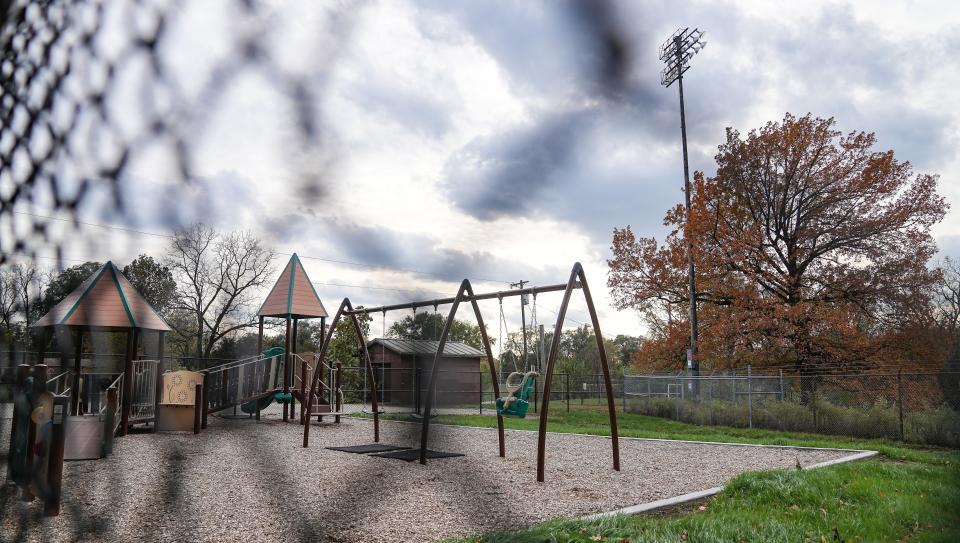 A playground is seen through a fence Wednesday, Nov. 1, 2023, at Day Early Learning at T.C. Howe Middle School in Indianapolis.