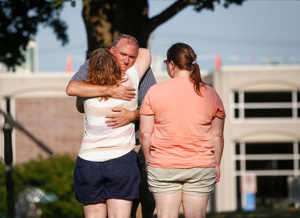 Cedar Falls mayor Rob Green hugs Jana and Karen Moorehouse, sisters of Sarah Schmidt, during a celebration of life service on Tuesday, Aug. 2, 2022, for Tyler and Sarah Schmidt and their 6-year-old daughter, Lula, who were killed in a shooting in the Maquoketa Caves State Park.