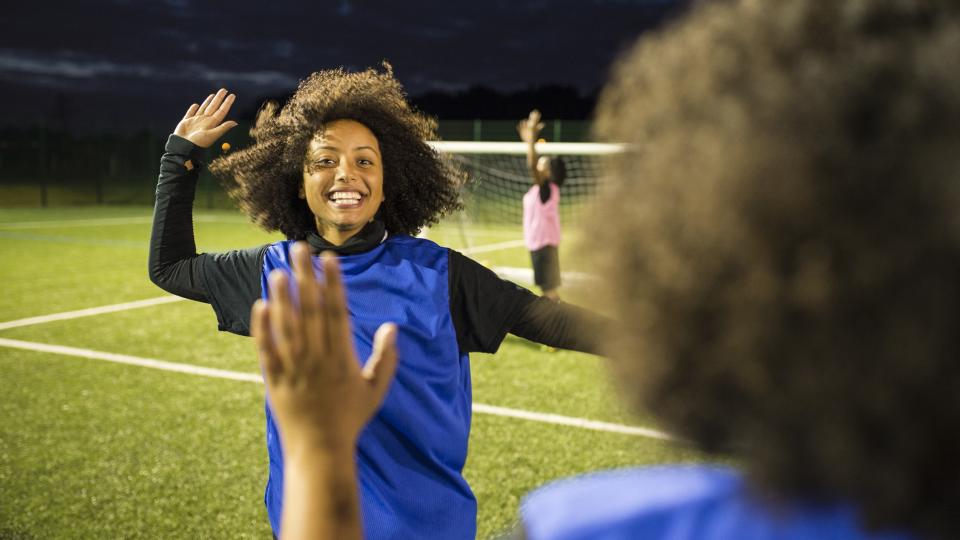 Teen girl playing football