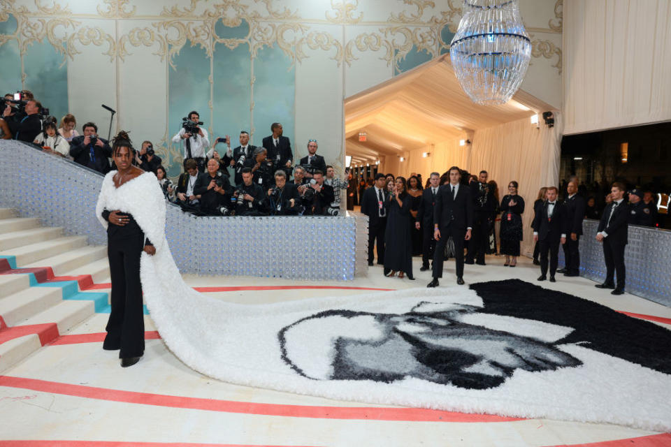 Jeremy Pope attends The 2023 Met Gala in a coat with Karl Lagerfeld's face on it