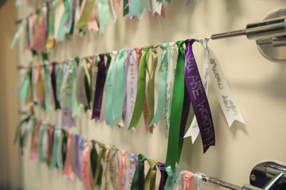 Words of encouragement are written on ribbons used to tie shopping bags for clients at Dress for Success, an EmBe women's program, in downtown Sioux Falls.