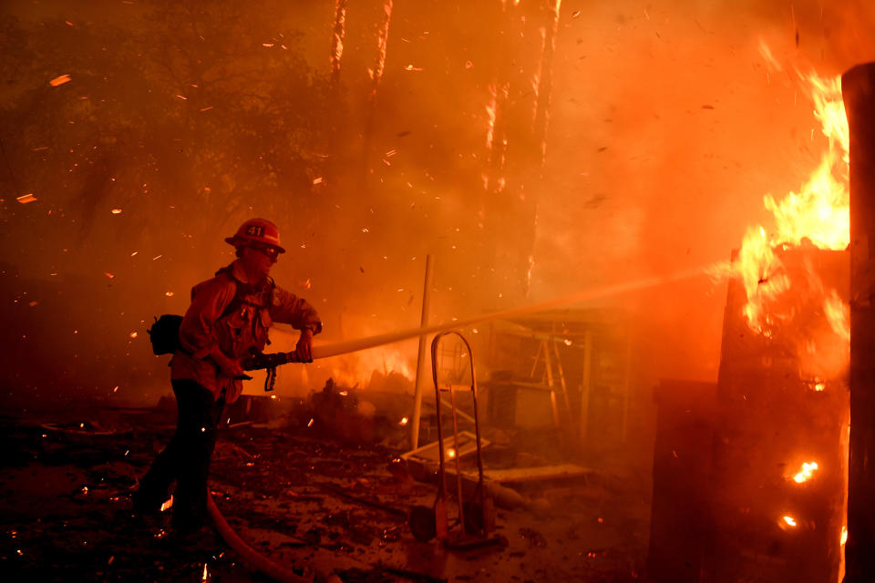 <p>A firefighter battles the Thomas Fire along Highway 33 in Casita Springs, California, on December 5. </p>