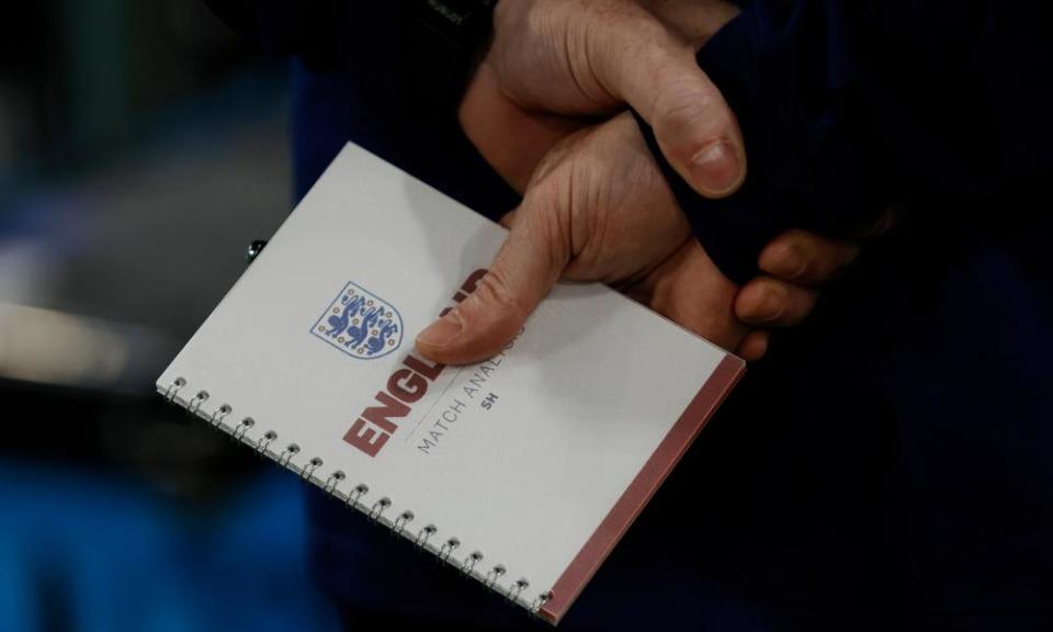 Steve Holland, England’s assistant manager, holds his tactics notebook just before kick-off for the last-16 win against Senegal.