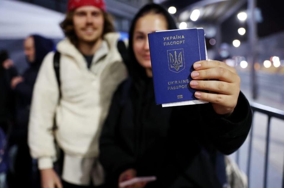 Ukrainian Sasha, who is seeking asylum in the U.S., displays her passport as she waits to cross the U.S.-Mexico border at the San Ysidro Port of Entry amid the Russian invasion of Ukraine on April 5, 2022 in Tijuana, Mexico.(Photo by Mario Tama/Getty Images)