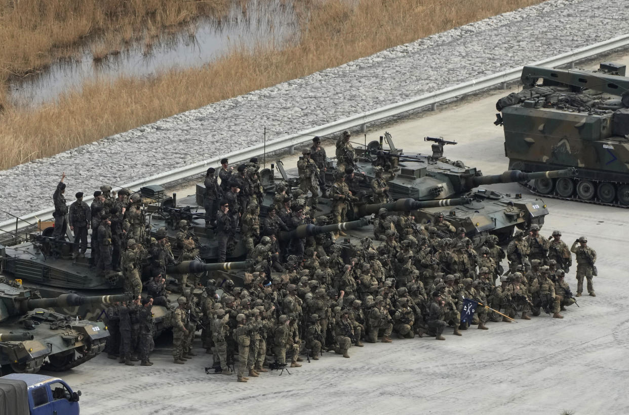 U.S. and South Korean, top, army soldiers gather before a combined live fire exercise between South Korea and the United States at Rodriguez Live Fire Complex in Pocheon, South Korea, Wednesday, March 22, 2023. North Korea launched multiple cruise missiles toward the sea on Wednesday, South Korea's military said, three days after the North carried out what it called a simulated nuclear attack on South Korea. (AP Photo/Ahn Young-joon)