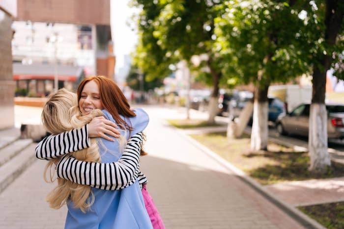 Two women hugging and smiling