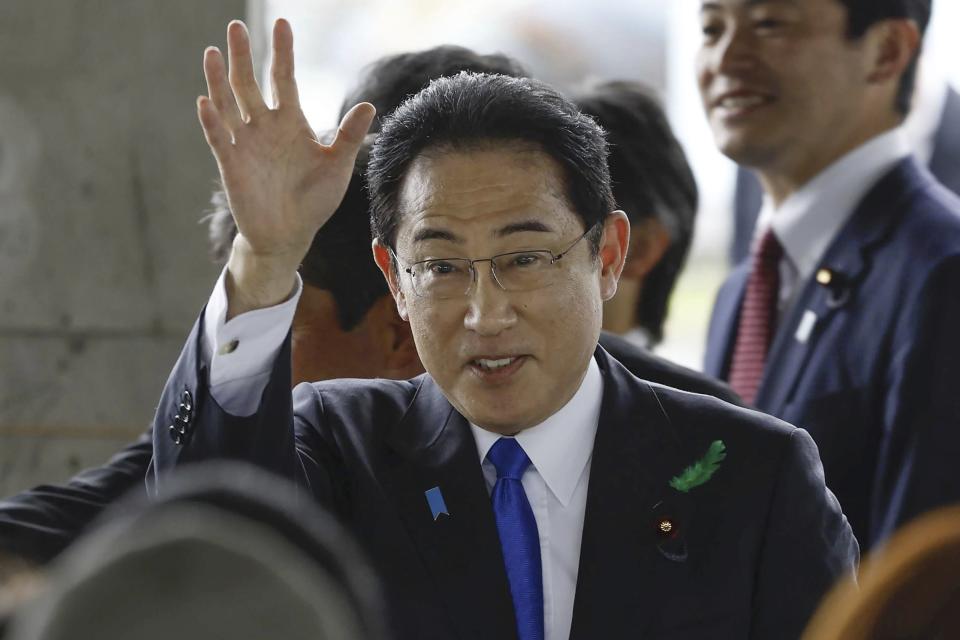 FILE - Japanese Prime Minister Fumio Kishida waves as he visits a port in Wakayama, western Japan on April 15, 2023. (Kyodo News via AP, File)