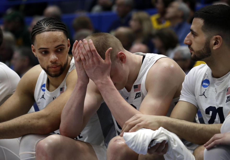 <p>Marquette’s Joey Hauser, middle, covers his face as teammates Theo John, left, and Joseph Chartouny, right, sit next to him during the second half of a first-round game against Murray State in the NCAA men’s college basketball tournament Thursday, March 21, 2019, in Hartford, Conn. Murray State won 83-64. (Elise Amendola/AP) </p>