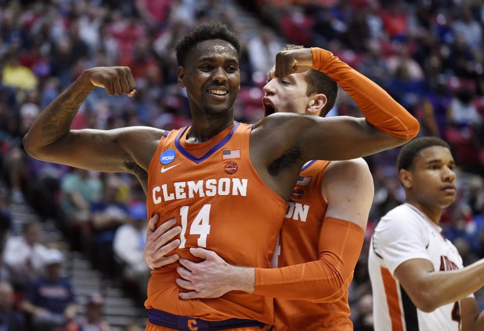 Clemson forward Elijah Thomas, front, celebrates a basket with forward David Skara during the first half of a second-round NCAA men’s college basketball tournament game against Auburn on Sunday, March 18, 2018, in San Diego. (AP Photo/Denis Poroy)