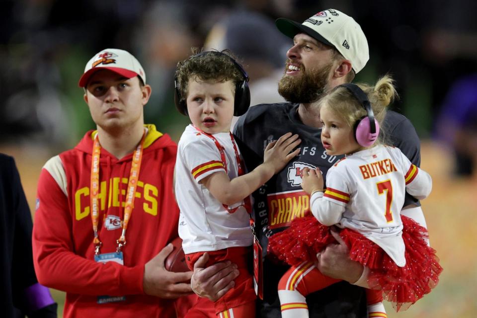 PHOTO: Harrison Butker, right, celebrates with his children after kicking the go ahead field goal to beat the Philadelphia Eagles in Super Bowl LVII at State Farm Stadium, Feb. 12, 2023, in Glendale, Ariz. (Carmen Mandato/Getty Images)