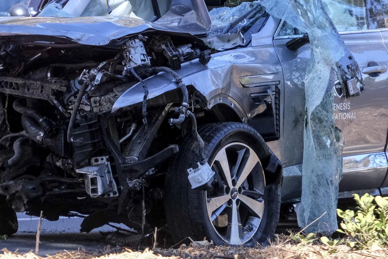 A vehicle rests on its side after a rollover accident involving golfer Tiger Woods along a road in the Rancho Palos Verdes suburb of Los Angeles on Tuesday, Feb. 23, 2021.