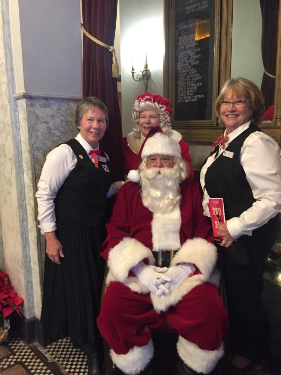 As Santa Claus, Cliff Roderiques and Judy Roderiques, as Mrs. Claus, pose with two other Zeiterion ushers during a matinee performance of "A Christmas Carol."