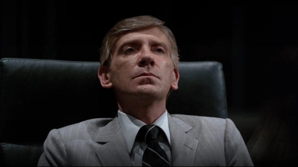 David Warner sits in his office looking annoyed in Tron.