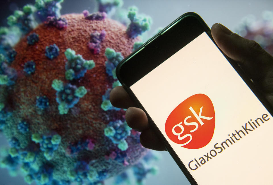 CHINA - 2020/03/23: In this photo illustration the British multinational pharmaceutical company GlaxoSmithKline (GSK) logo seen displayed on a smartphone with a computer model of the COVID-19 coronavirus on the background. (Photo Illustration by Budrul Chukrut/SOPA Images/LightRocket via Getty Images)