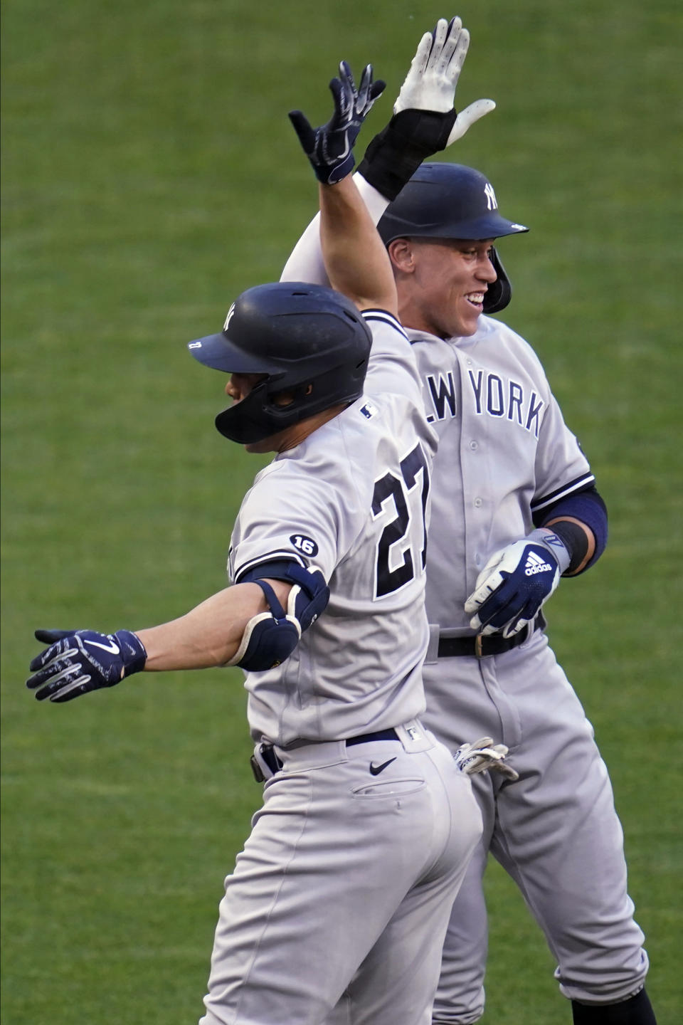 New York Yankees' Giancarlo Stanton (27) and Aaron Judge celebrate Stanton's three-run home run off Minnesota Twins' pitcher J.A. Happ during the first inning of a baseball game Thursday, June 10, 2021, in Minneapolis. (AP Photo/Jim Mone)