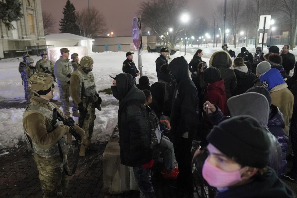 A group of protesters confront several National Guard members outside a museum, late Tuesday, Jan. 5, 2021, in Kenosha, Wis. Earlier it was announced that no charges will be filed against the white police officer that shot Jacob Blake, a Black man in August. (AP Photo/Morry Gash)