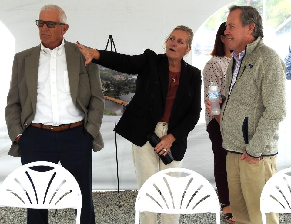 Coshocton County Commissioner Dane Shryock and Administrator Mary Beck talk with Philip McWane, president of McWane Ductile, at an opening of the McWane River Walk on County Road 1A. Funding for the project came from a $500,000 donation from the company.