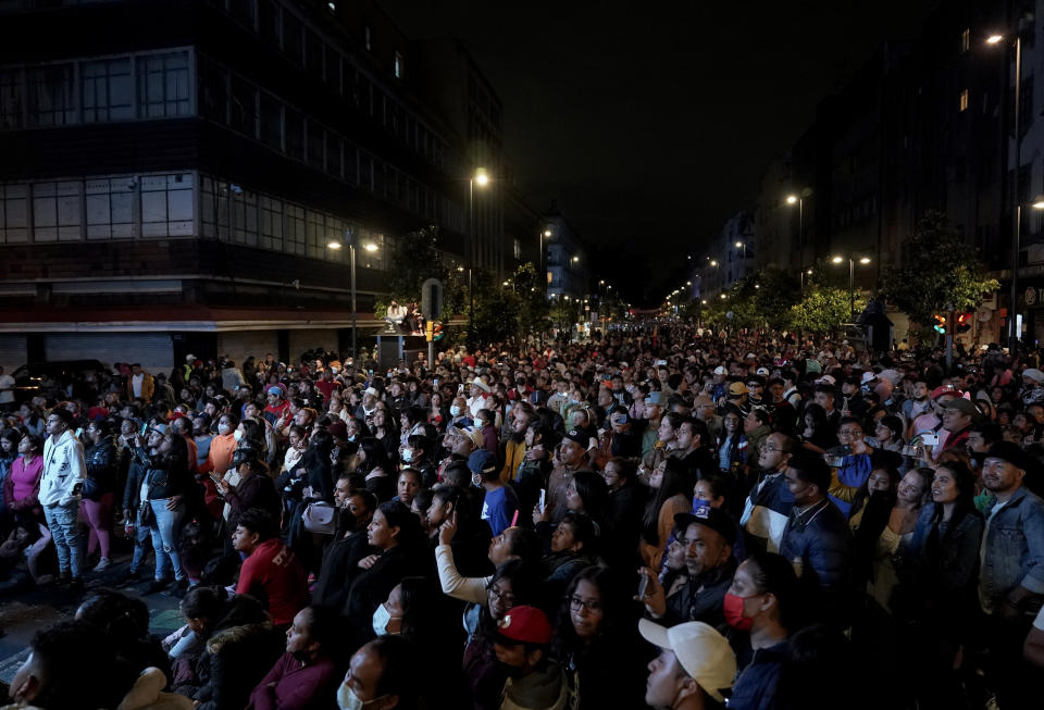 People attend a free concert by the Mexican regional band Grupo Firme in Mexico City's main square, the Zocalo, Sunday, Sept. 25, 2022. (AP Photo/Eduardo Verdugo)