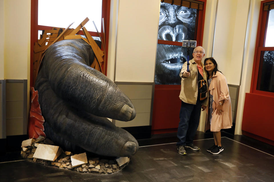 Visitors to the Empire State Building take a photo featuring an interactive King Kong exhibit, in New York, Thursday, Oct. 10, 2019. (AP Photo/Richard Drew)