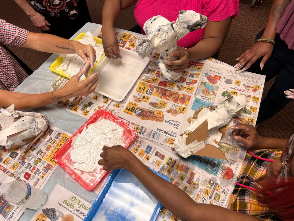 Telfair Museums' Outreach Program particpants apply plaster gauze to their beastly forms.