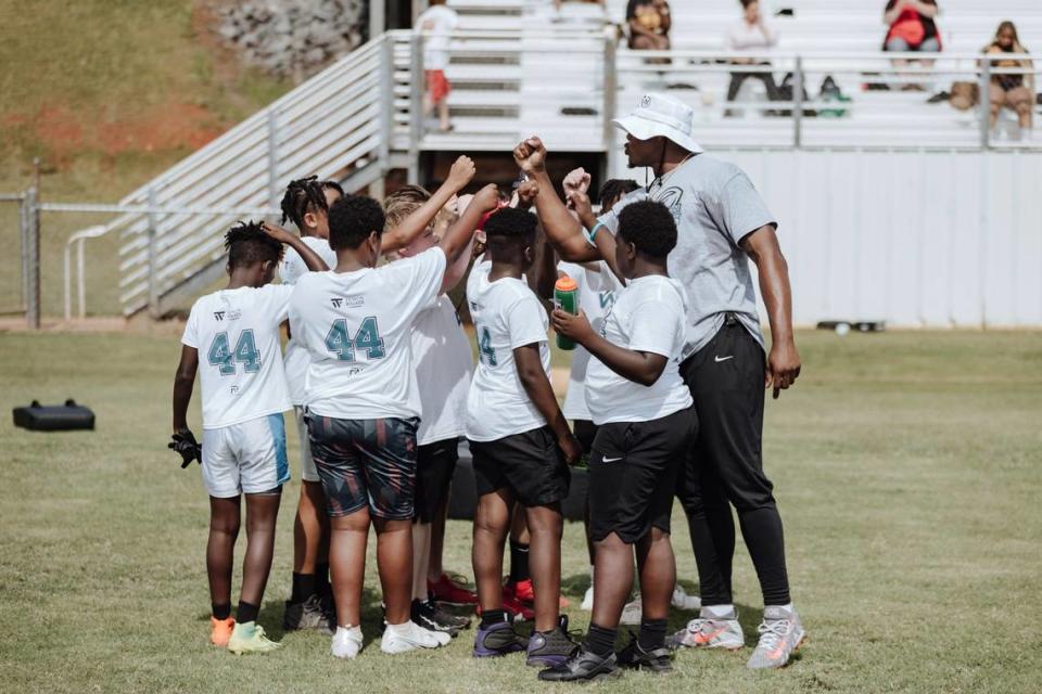 Jacksonville Jaguars Travon Walker huddles up with young athletes at his inaugural youth football camp in 2023. The NFL linebacker will host his 2nd annual camp on Saturday in Thomaston along with an autograph signing event in Macon Friday evening.