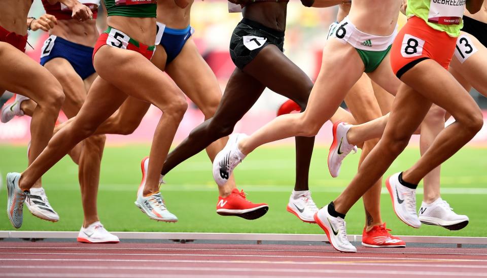 Competitors race down the back stretch in the 1,500m race.