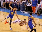 May 24, 2016; Oklahoma City, OK, USA; Golden State Warriors guard Stephen Curry (30) jumps over a diving Oklahoma City Thunder guard Russell Westbrook (0) during the second half in game four of the Western conference finals of the NBA Playoffs at Chesapeake Energy Arena. Mandatory Credit: Kevin Jairaj-USA TODAY Sports