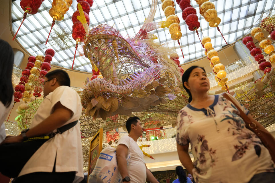 A giant wood dragon is displayed at a mall at Binondo district, said to be the oldest Chinatown in the world, in Manila, Philippines on Tuesday Feb. 6, 2024, Crowds are flocking to Manila's Chinatown to usher in the Year of the Wood Dragon and experience lively traditional dances on lantern-lit streets with food, lucky charms and prayers for good fortune. (AP Photo/Aaron Favila)