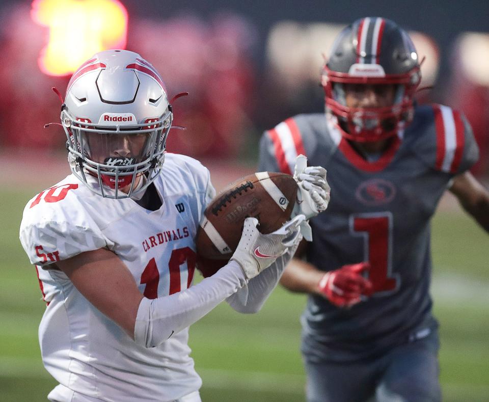 Sandy Valley's Chapin Greer reels in a pass in the second half with pressure from Canton South's Xavier Williams at Canton South , Friday September 2, 2022.