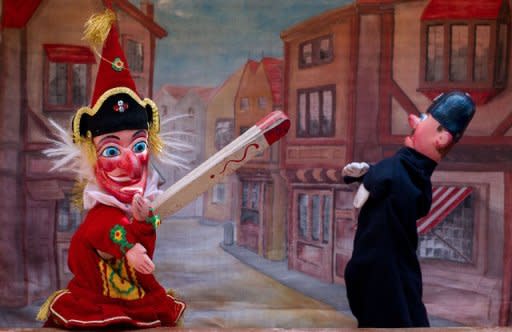 Mr Punch (L) hits a police puppet in a traditional Punch & Judy show during a weekend of performances and shows. Dozens of puppeteers gathered in central London on Sunday to celebrate 350 years of the Punch and Judy show, an anarchic English seaside entertainment known for its slapstick and casual violence