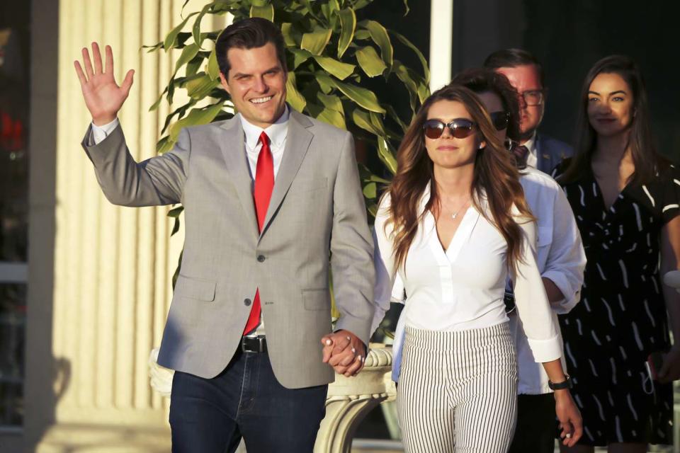 Representative Matt Gaetz, a Republican from Florida, waves as he arrives with his fiancee, Ginger Luckey, for the Save America Summit in Doral, Florida, U.S., on Friday, April 9, 2021