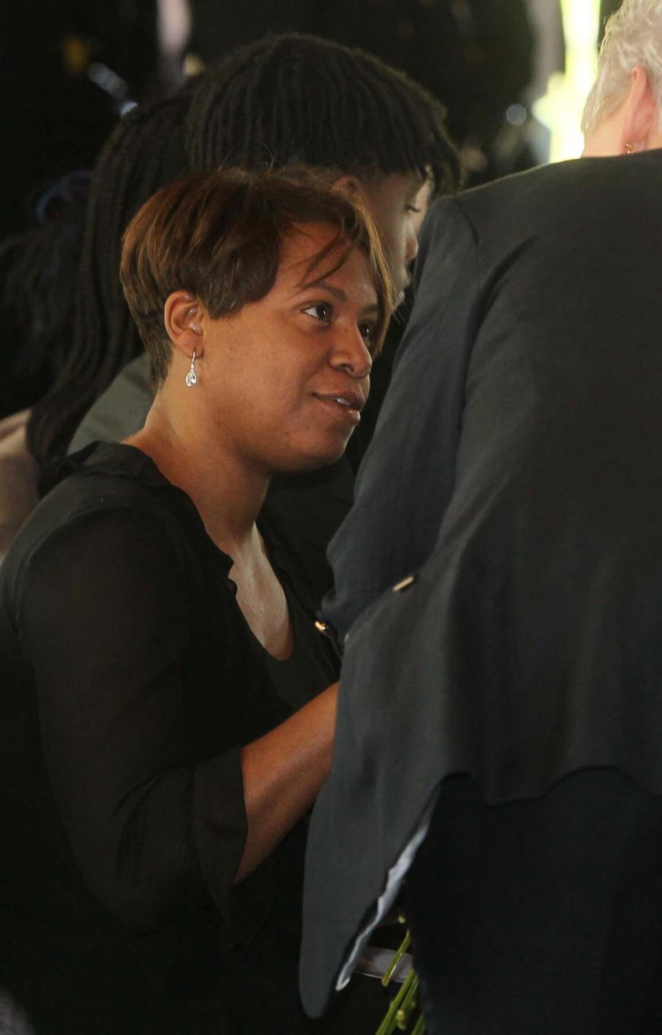 Stacy Hairston-Jones, the widow of Akron Police Officer Kenneth C. Jones accepts flowers from a member of the Akron FOP Auxiliary 1 during the Akron Police Memorial Day ceremony at the Fraternal Order of Police Akron Lodge 7 on Wednesday.  Officer Jones died from cardiac arrest following an event on the job in 2020.