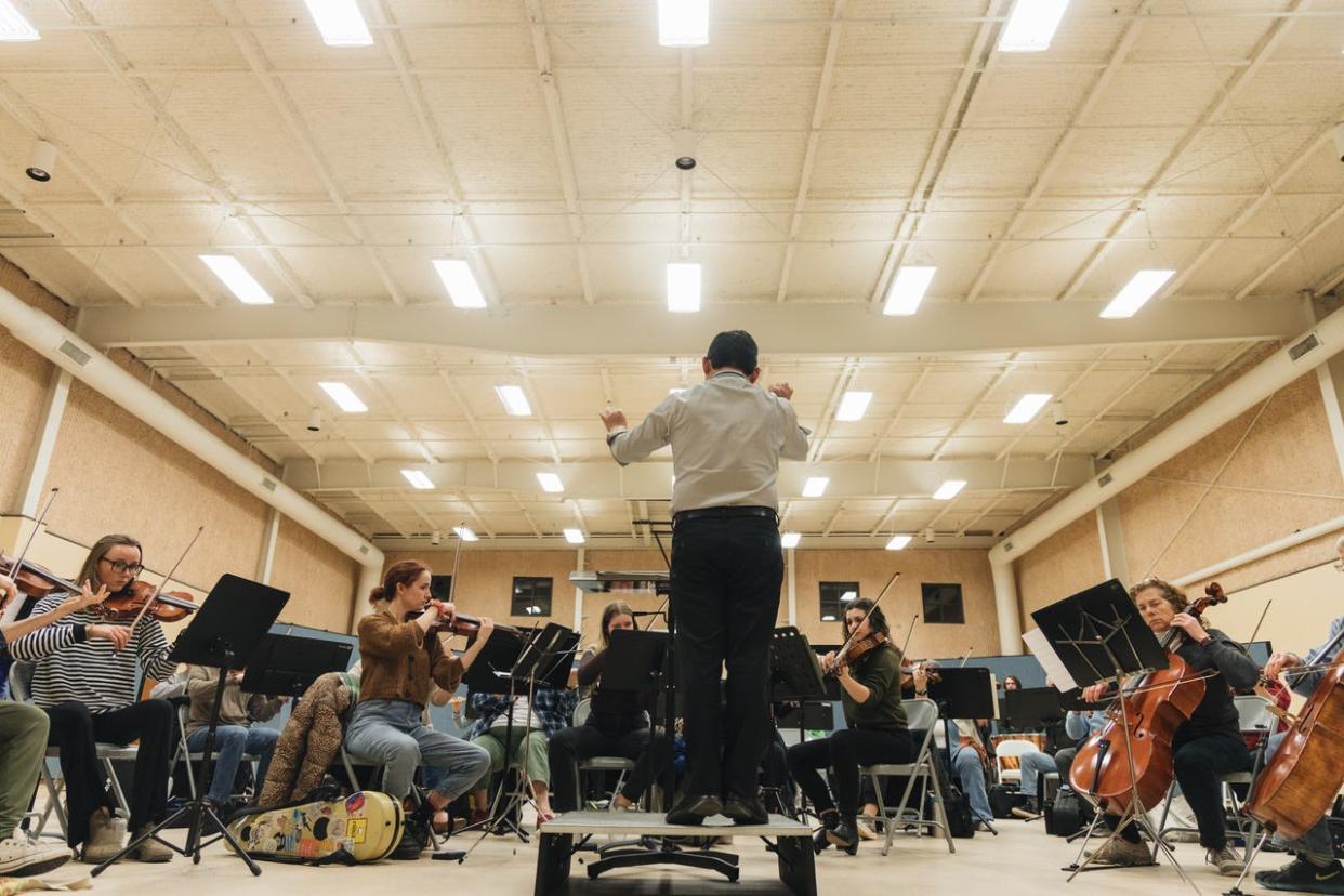 Ryo Hasagawa conducts the Bloomington Symphony Orchestra during a recent practice session. The orchestra will present Un Voyage Francais in a concert May 12 at the Buskirk-Chumley Theater.