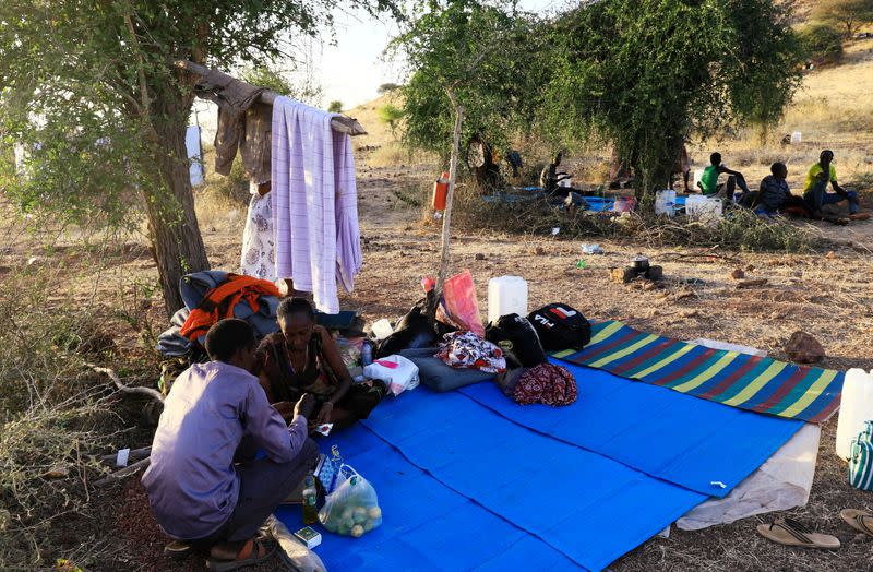 Ethiopians who fled war in Tigray region, rest under trees with their belongings at the Um-Rakoba camp on the Sudan-Ethiopia border in Al-Qadarif state