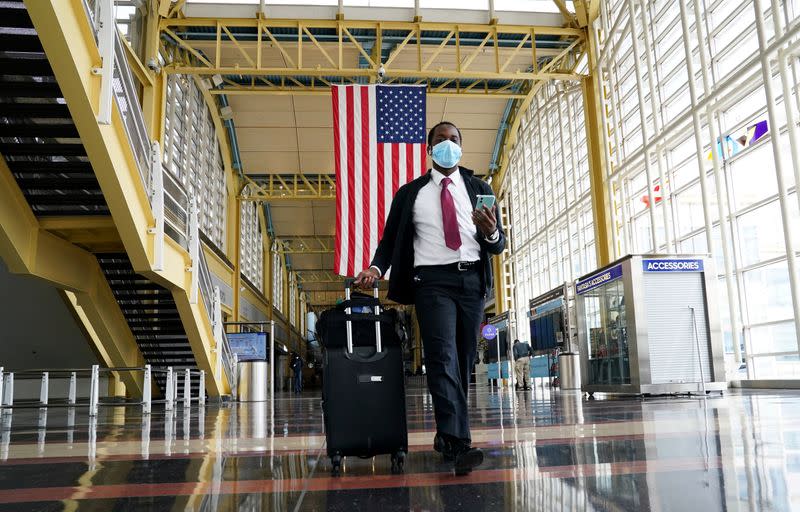 Passenger walks through Reagan National airport as air travel continues to be minimal in Washington