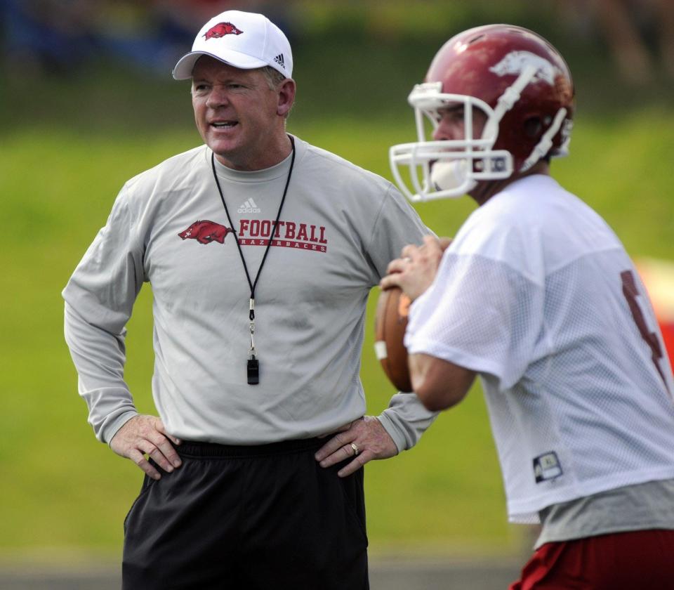 Arkansas football coach Bobby Petrino shouts at his offense during the Razorbacks' first day of practice in Fayetteville, Ark. Petrino received a hero's welcome when he came to Arkansas, but he was vilified elsewhere because he left the Atlanta Falcons and the Michael Vick nightmare without telling his players face-to-face. No matter what Arkansas does this year, Petrino will be the center of attention. 