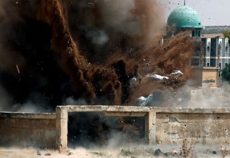 Civil defense members safely detonate cluster bombs in the rebel-held area in Deraa, Syria July 26, 2017. REUTERS/Alaa al-Faqir