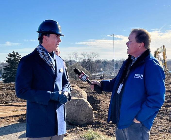 Hall of Fame Village CEO Michael Crawford is interviewed by a Cleveland television reporter at a groundbreaking event in December for a football-themed indoor water park.