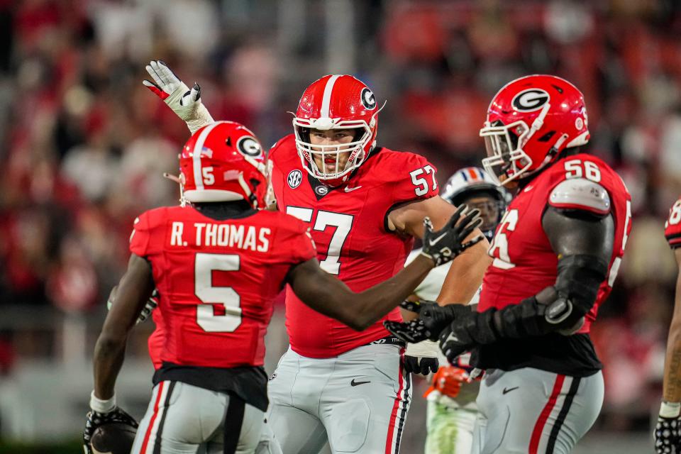 Sep 2, 2023; Athens, Georgia, USA; Georgia Bulldogs wide receiver Rara Thomas (5) reacts with offensive lineman Monroe Freeling (57) after making a catch on a long pass against the Tennessee Martin Skyhawks during the second half at Sanford Stadium. Mandatory Credit: Dale Zanine-USA TODAY Sports