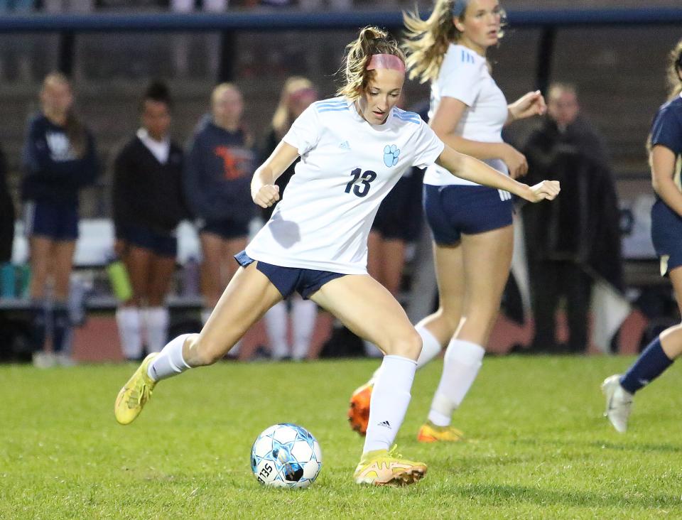 MMU's Finley Barker sends a pass up the field during the Cougars 1-0 win over Essex under the lights in 2022.