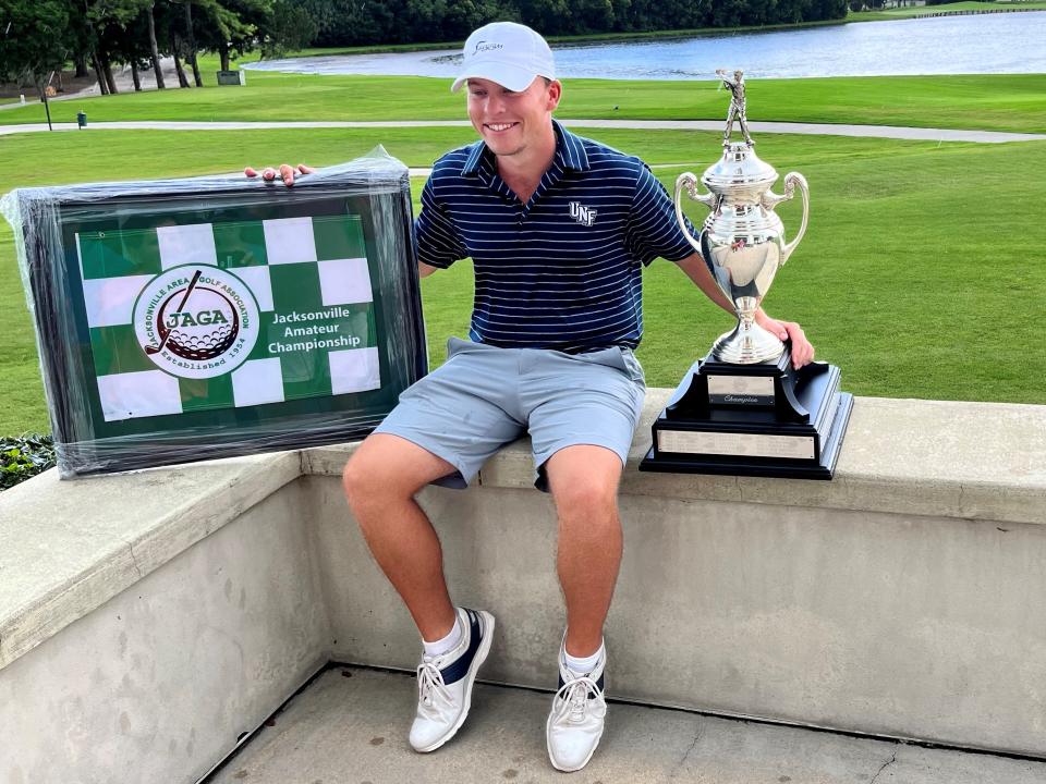 Jason Duff displays his trophy and plaque for winning the Jacksonville Area Golf Association Jacksonville Amateur on Saturday at the Deerwood Country Club.