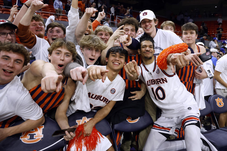 Auburn guard Chad Baker-Mazara (10) celebrates with fans after Auburn defeated South Carolina in an NCAA college basketball game Wednesday, Feb. 14, 2024, in Auburn, Ala. (AP Photo/Butch Dill)