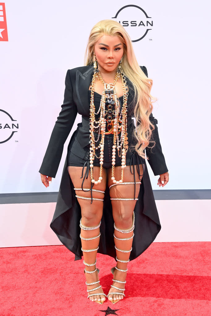 Lil' Kim attends the BET Awards 2021 in a matching blazer and shorts accessorized with long chains pearls